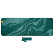 Yoga mat unrolled showing texture and marble pattern, with strap and guide.
