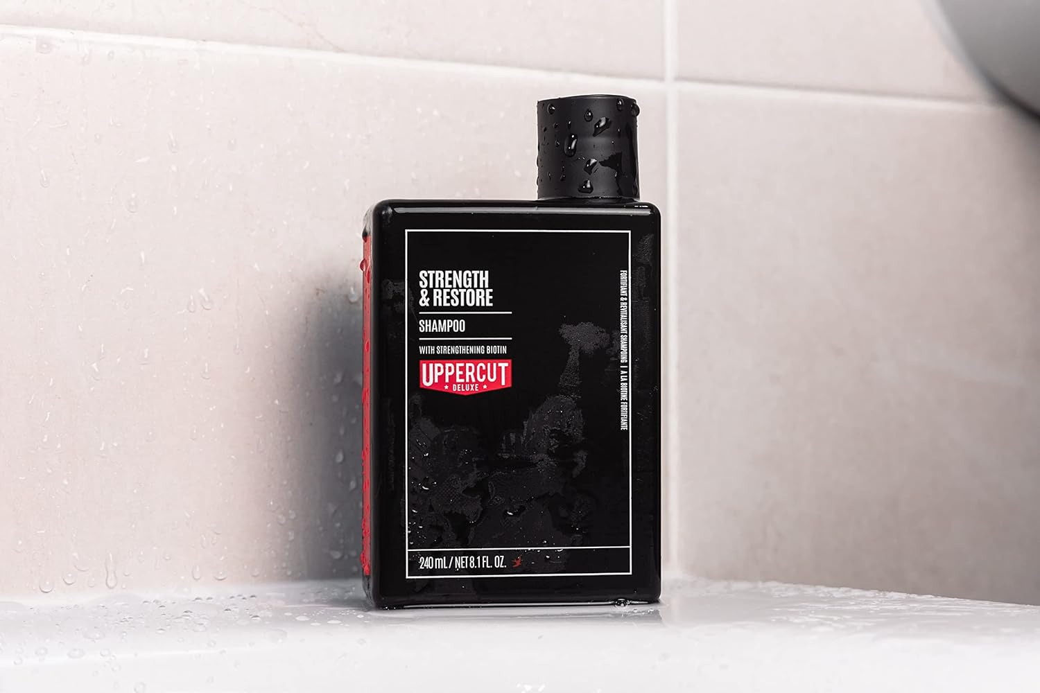 Lifestyle/use image: Uppercut Deluxe Strength and Restore Shampoo 240ml men hair care routine