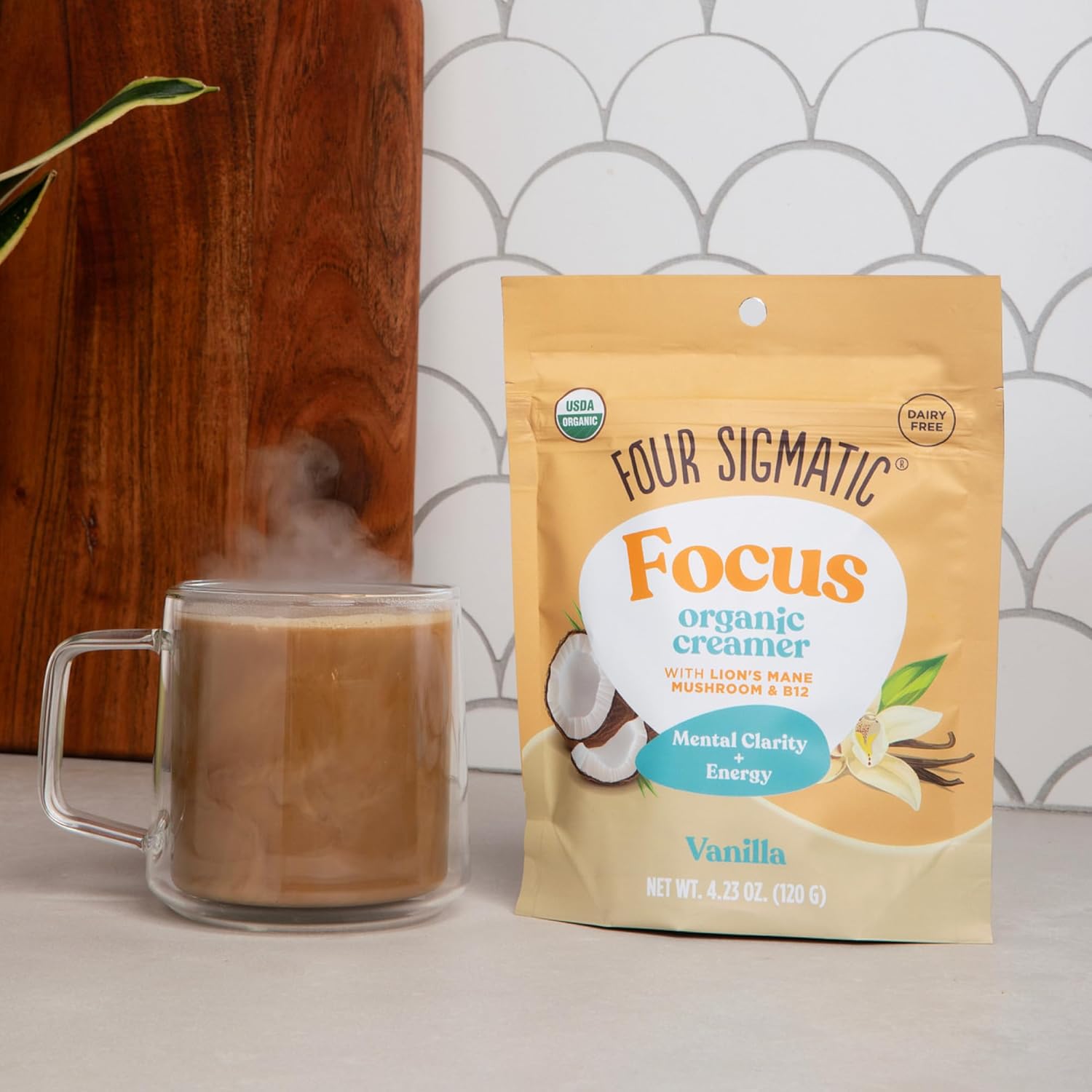 Four Sigmatic creamer to a steaming mug.