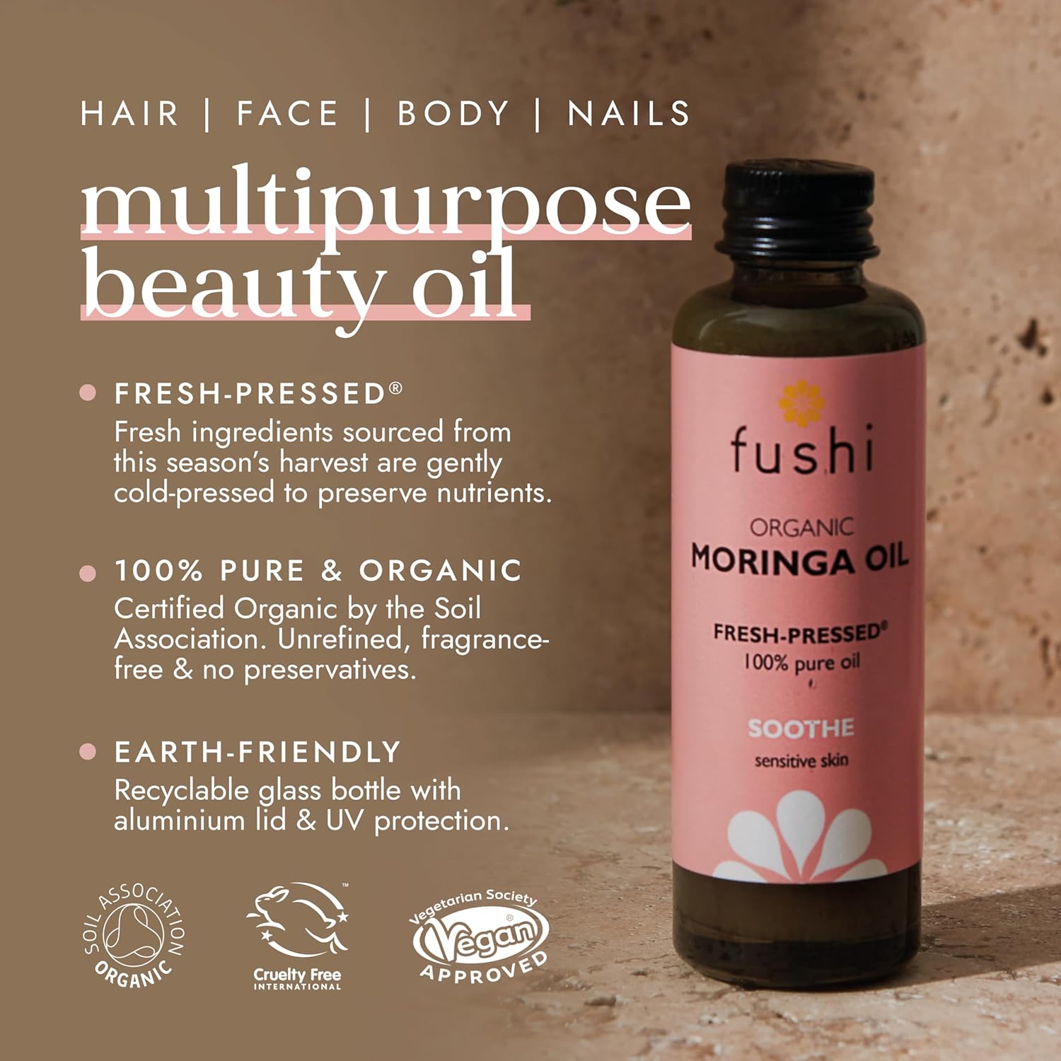 Fushi Organic Moringa Oil bottle with product details on a brown background