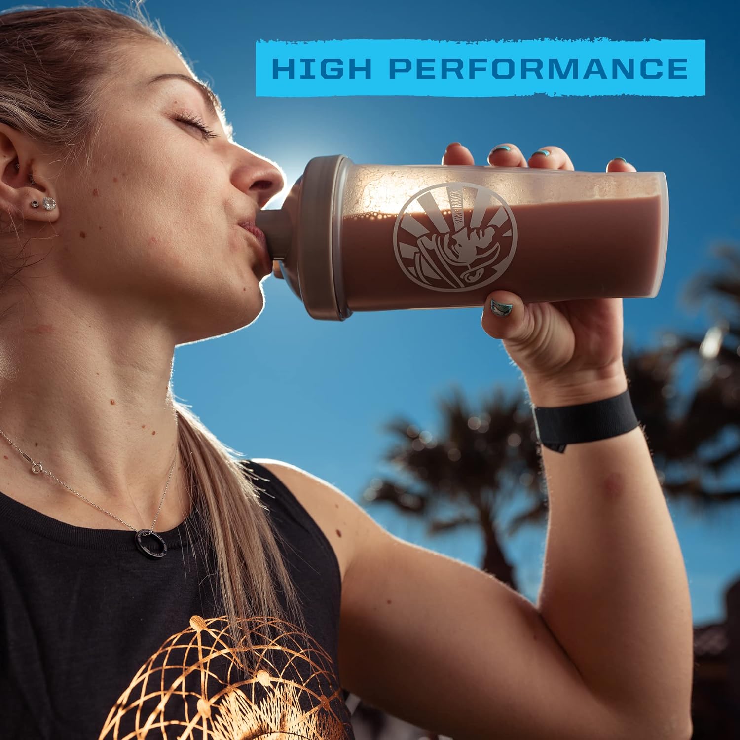 Sunwarrior chocolate protein powder being mixed in a shaker bottle.