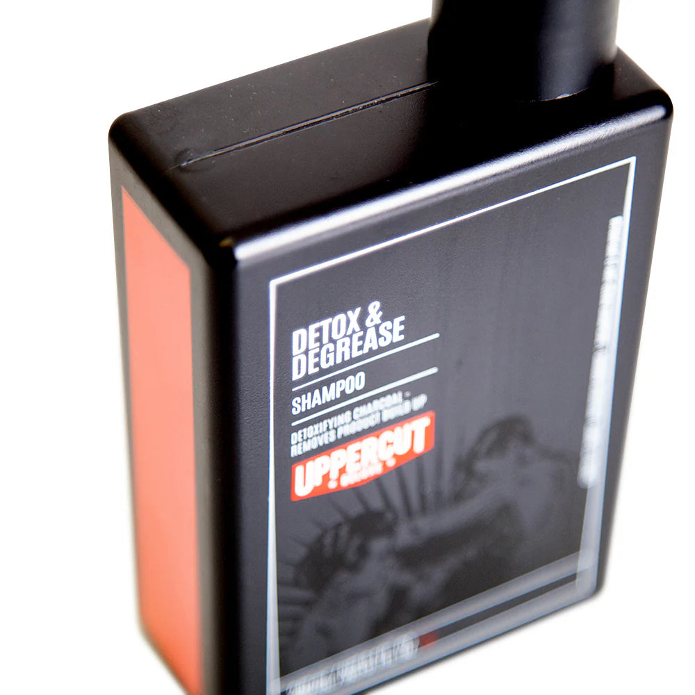 Side image: Uppercut Deluxe Detox and Degrease Shampoo 240ml bottle charcoal formula packaging