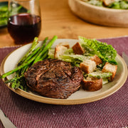 Lifestyle/use image: Kinder's The Steak Blend Seasoning used on steaks burgers and grilled foods 362g