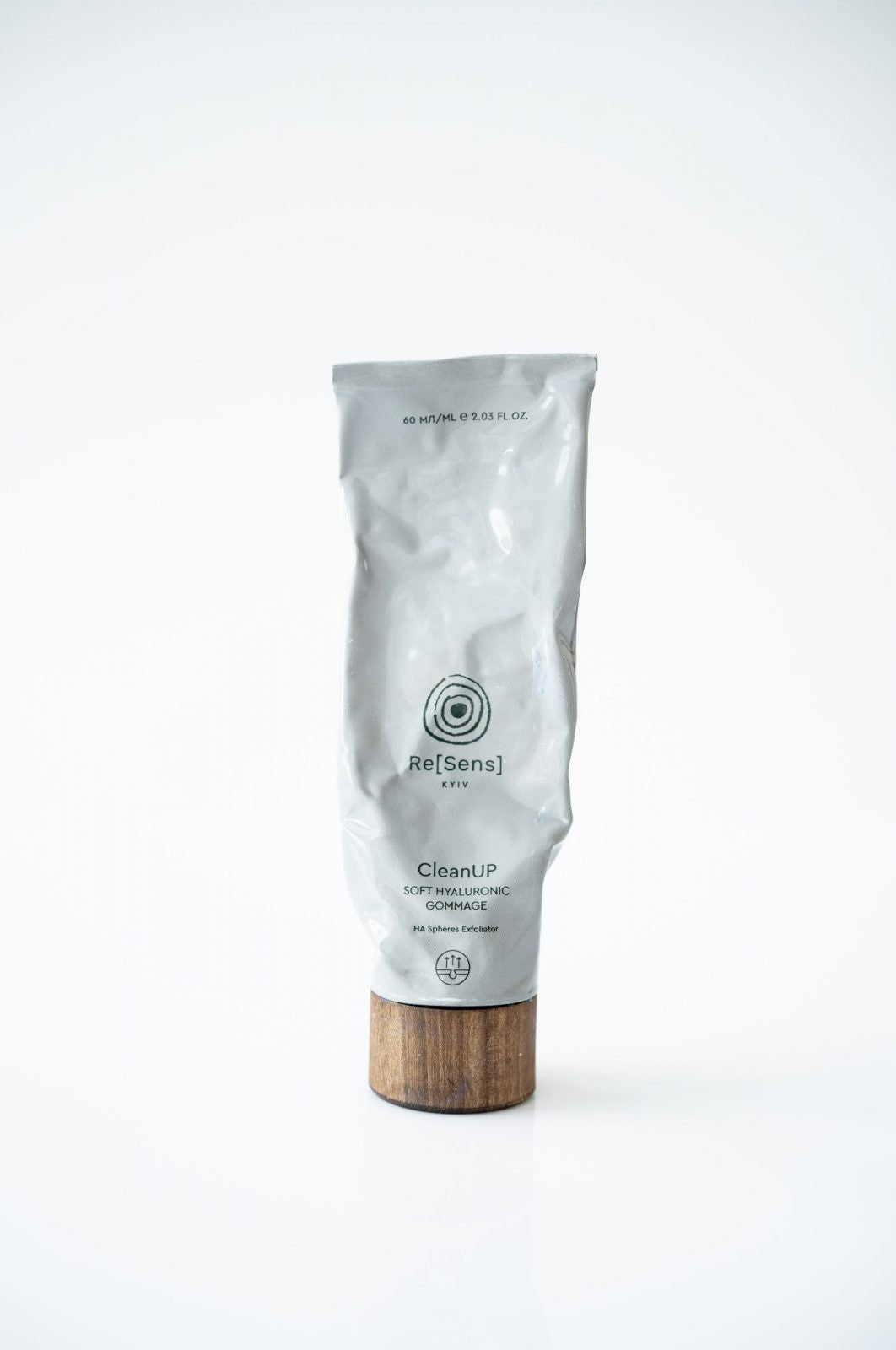 Skincare product with wooden applicator on a white background